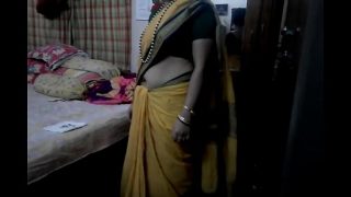 Desi Tamil milf flaunting her bare midriff in a tight saree, moaning softly